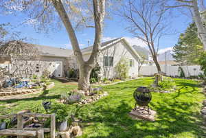 Exterior space with a yard, fence, and an outdoor fire pit