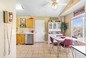 Kitchen featuring light countertops, a ceiling fan, visible vents, stainless steel dishwasher, and a sink