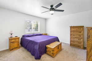 Bedroom featuring ceiling fan and light colored carpet