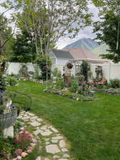 View of yard featuring a fenced backyard and a mountain view