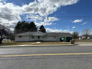 Single story home with concrete driveway and a garage