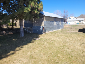 Exterior space featuring a yard and fence