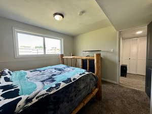 Bedroom with carpet flooring and baseboards