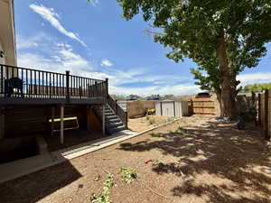 Fenced backyard featuring stairway and a deck
