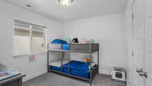 Bedroom with carpet floors, baseboards, and visible vents