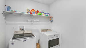 Laundry area with laundry area and washing machine and clothes dryer