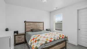 Carpeted bedroom with visible vents