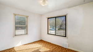 Empty room with baseboards, carpet, and visible vents