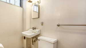 Half bath featuring toilet and a sink