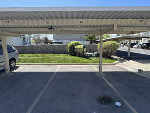 Covered parking lot featuring fence