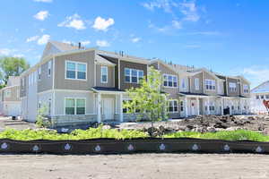 View of property featuring board and batten siding and a residential view