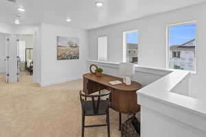 Office space with light colored carpet, baseboards, visible vents, and recessed lighting