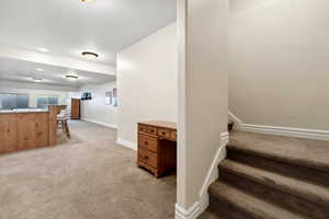 Stairway with baseboards and carpet floors