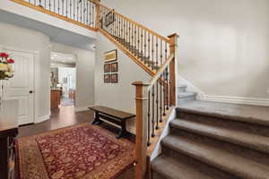 Staircase featuring recessed lighting, baseboards, and wood finished floors