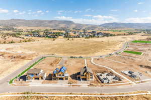 Aerial view of sparsely populated area featuring nearby suburban area and a mountain backdrop