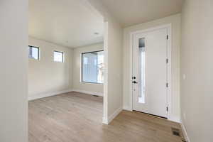 Entryway featuring baseboards and light wood-style floors