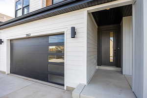 Doorway to property featuring an attached garage