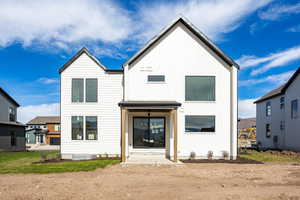 View of front of property featuring a patio and board and batten siding