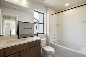 Bathroom featuring vanity,  shower combination, and recessed lighting