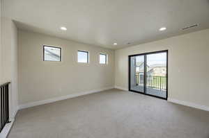 Spare room with light carpet and recessed lighting