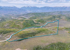 Aerial view of property's location featuring property parcel outlined and a mountainous background