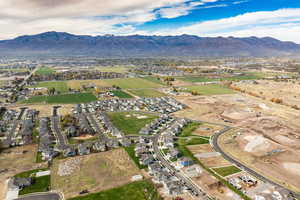 Aerial view of property's location featuring a mountainous background and nearby suburban area