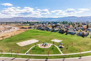Aerial view of residential area with a park and a mountain backdrop