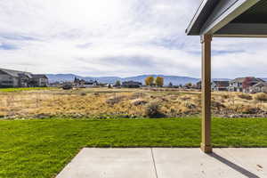 View of yard featuring a mountain view and a patio