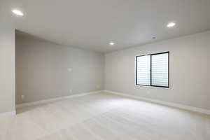 Spare room featuring light carpet and recessed lighting