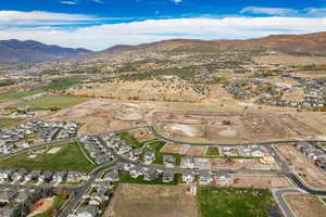 Aerial overview of property's location with nearby suburban area and a mountainous background