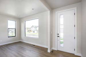 Foyer entrance with wood finished floors