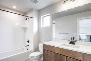 Bathroom featuring shower / bathtub combination, vanity, and recessed lighting