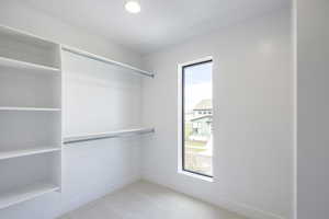 Spacious closet with light carpet