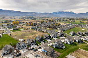 Aerial view of property and surrounding area with a mountainous background