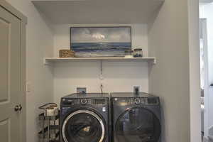 Laundry area featuring washing machine and clothes dryer and laundry area