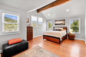 Bedroom featuring light wood finished floors, lofted ceiling with beams, baseboards, and recessed lighting