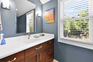 Bathroom with vanity and vaulted ceiling