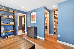 Bedroom with wood finished floors, baseboards, and recessed lighting
