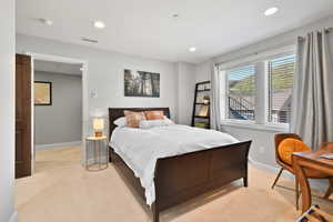Bedroom featuring light carpet, recessed lighting, visible vents, and baseboards