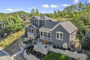 Back of house with roof with shingles, fence, a balcony, a mountain view, and central AC unit