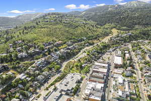 Drone / aerial view with a wooded view, a mountain view, and a residential view