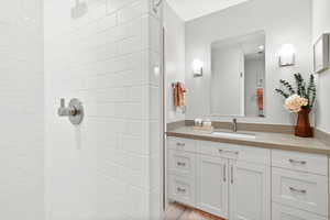 Bathroom with a tile shower and vanity