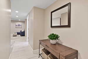 Corridor with baseboards and recessed lighting