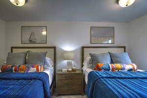 Bedroom with a textured ceiling and carpet flooring