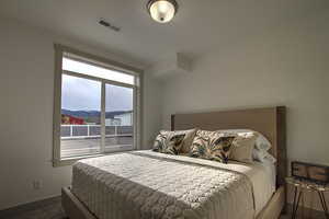Carpeted bedroom featuring visible vents and baseboards