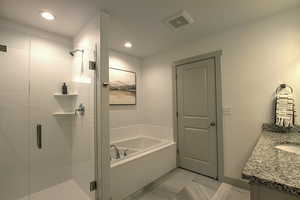 Full bathroom featuring vanity, a bath, marble finish floor, and a stall shower