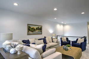 Living room with recessed lighting and light carpet