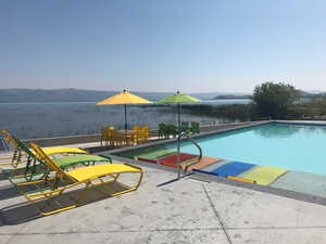 Outdoor pool featuring a patio and a mountain view