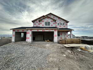 Unfinished property with gravel driveway