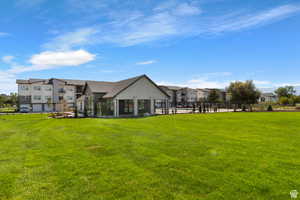 Back of house featuring a lawn and a residential view